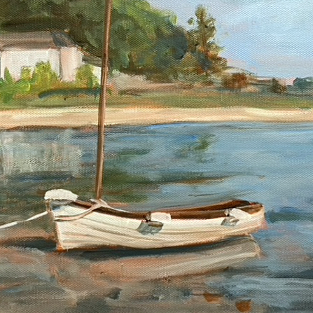 Small sailing dinghy tied up near a shoreline. In the background is a shoreline with a house and trees in the background. 